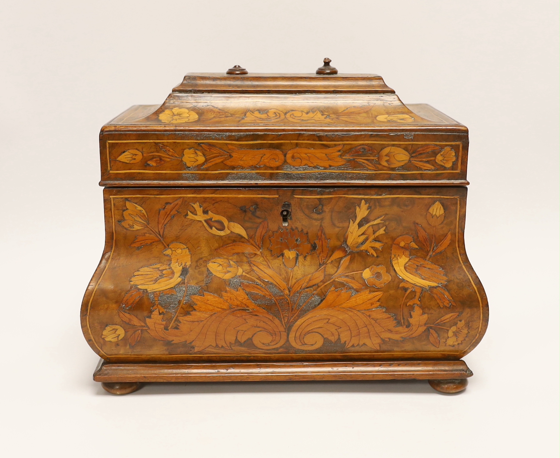 An 18th century Dutch floral marquetry bombé shaped tea caddy, 26cm wide